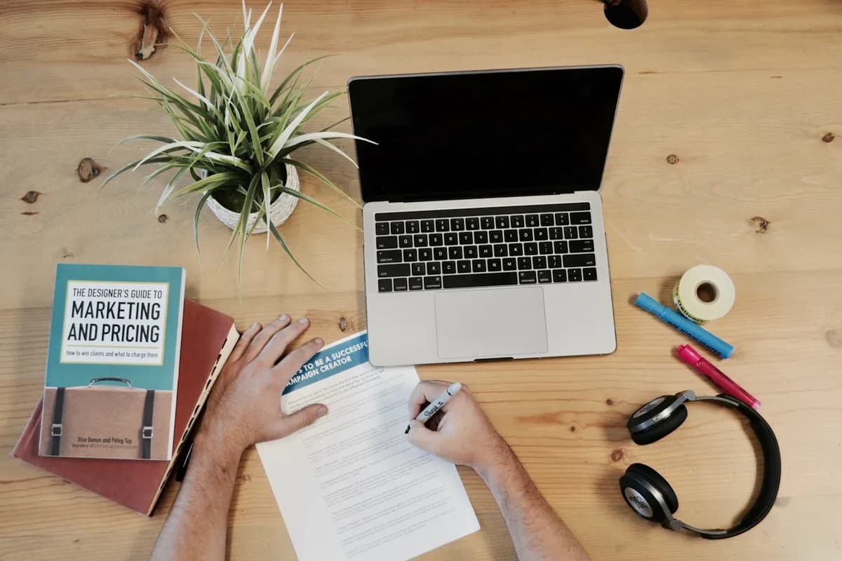 Un carnet de stratégie marketing, un ordinateur portable et des notes de tarification